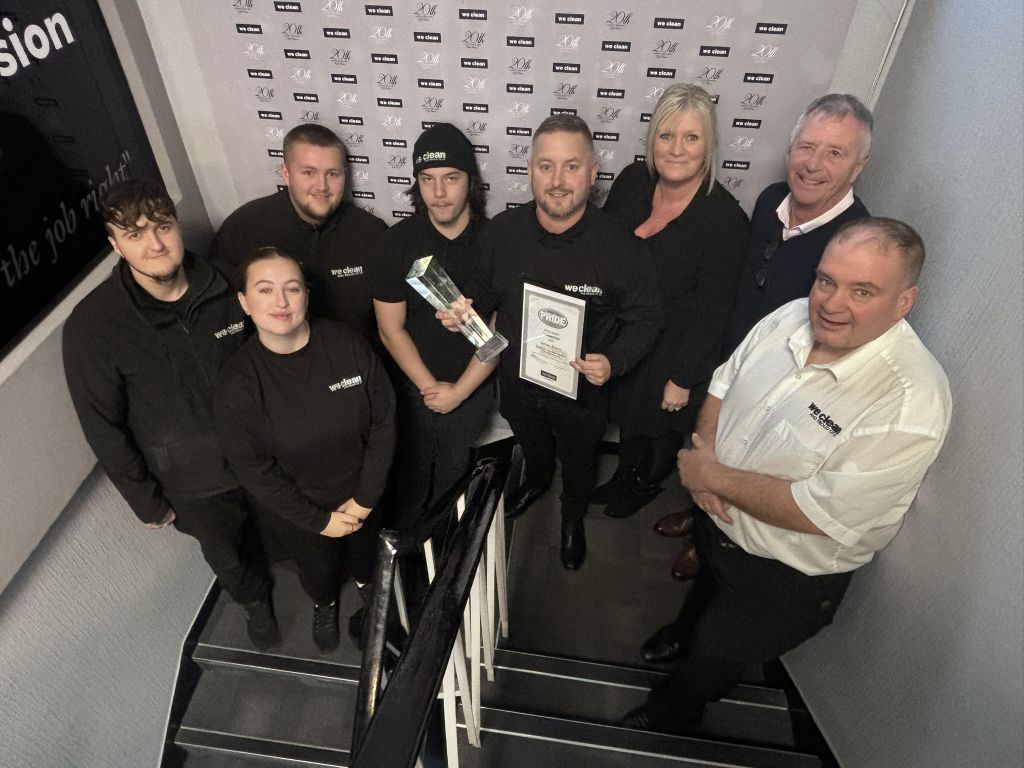 James Alcock pictured receiving his Pride Champion Award alongside his colleagues within the We Clean Specialist Division.