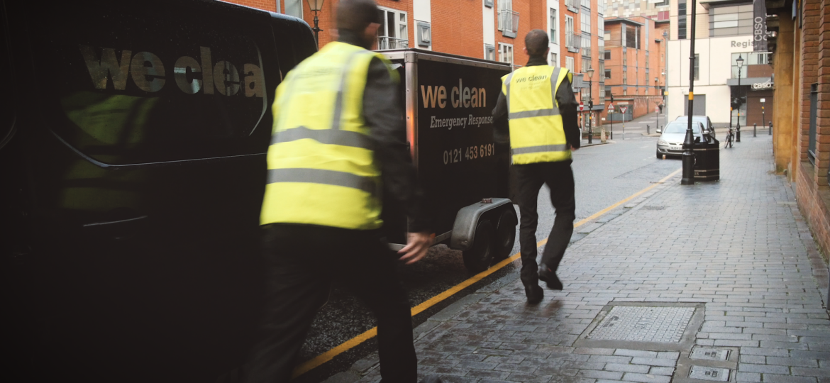 Cleaning operatives arriving quickly on site to deliver professional emergency cleaning services response in an urban workplace location.
