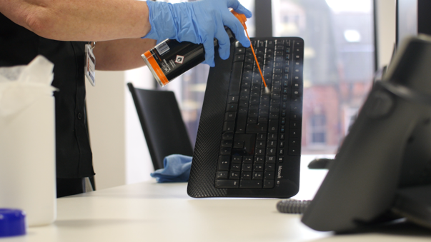 IT equipment cleaning services being used to sanitise a computer keyboard with specialist cleaning products.